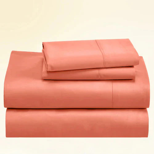 "CinchFit King Sheet Set in coral, 400TC cotton with 15-inch depth. Vibrant USA-made bedding with secure corded fit."